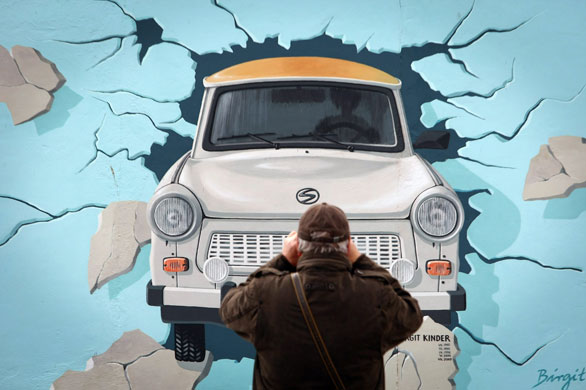 24 Hours in Pics: A visitor takes a snapshot of the Berlin Wall