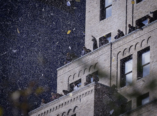 24 Hours in Pics: Confetti falls during a ticker-tape parade along Broadway