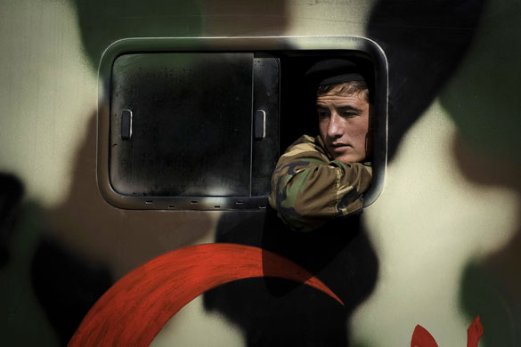 24 Hours in Pics: An Afghan army medic soldier looks out from an ambulance in Kabul