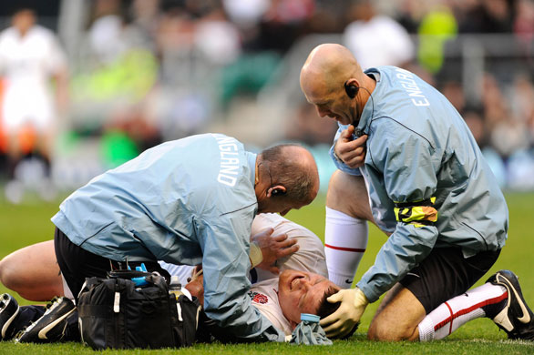 England v Australia: The physios treat David Wilson's left shoulder as he grimaces in pain