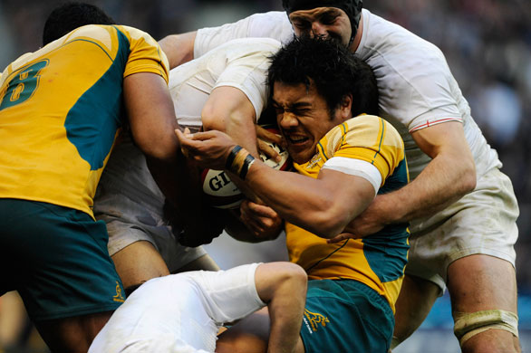 England v Australia: Digby Ioane holds onto the ball despite being tackled by 3 England players