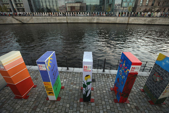 Berlin Wall celebrations: Painted styrofoam dominoes stand by the Spree canal in Berlin, Germany