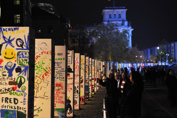 Berlin Wall celebrations: People look at the individually painted dominos along the former route