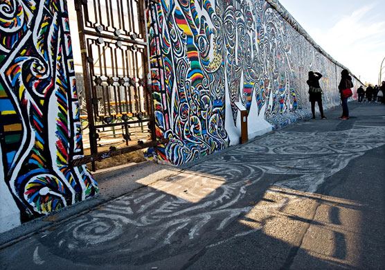 Berlin Wall celebrations: Tourists take photographs of the murals painted on the Berlin Wall