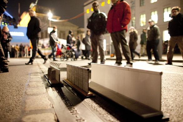 Berlin Wall celebrations: Miniature replicas of the Berlin wall are displayed at the Brandenburg Gate