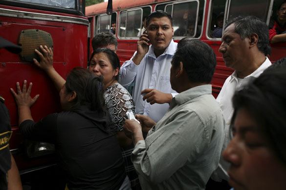Guatemala morticians: Funeral salesmen try to sell funeral packages to relatives of a shot man 