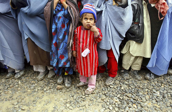 24 hours in pictures: A displaced Afghan child queues to receive winter aid 
