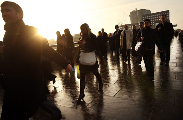 Week in Business: City workers walk across London Bridge on their commute