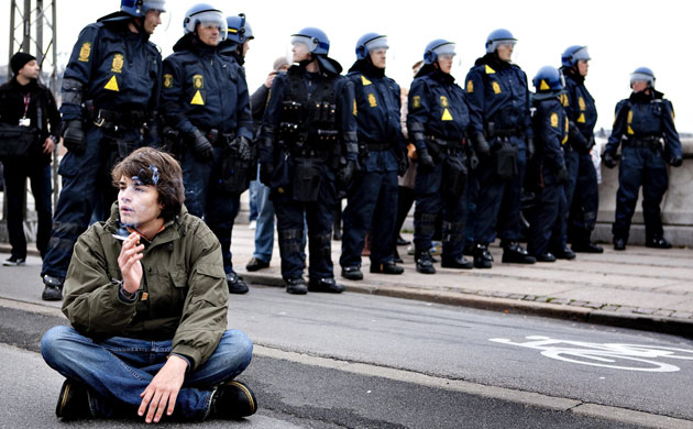Copenhagen diary: COP15 An activist rests next to police men during a demonstration