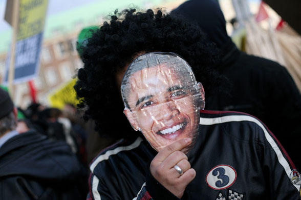 Copenhagen climate summit: A protestor wears a mask depicting Barack Obama