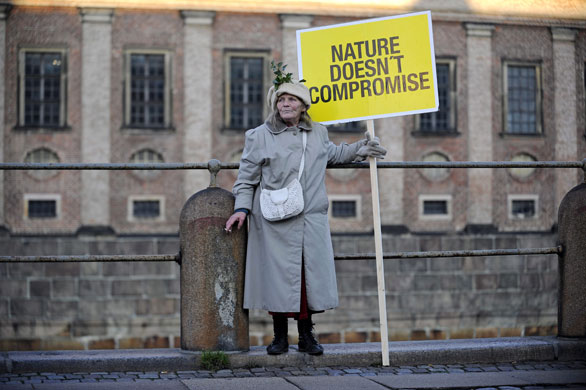 Copenhagen climate summit: A woman carries a sign as she takes part in a demonstration