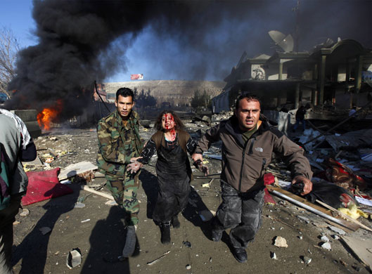 Eyewitness: A woman is led away from the scene of a bomb attack in Kabul