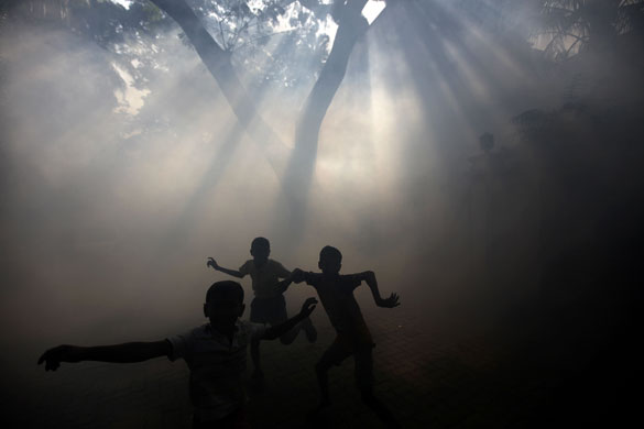 Eyewitness: Boys playing in an area of Mumbai made misty by fumigation