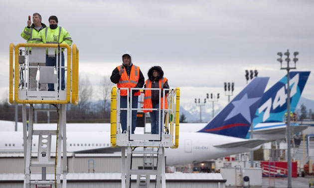 Dreamliner 787: Boeing employees watch the first flight of the Boeing 787 Dreamliner jet