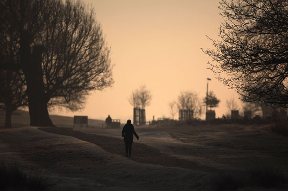 December weather: A woman walks through the frost in Richmond Park