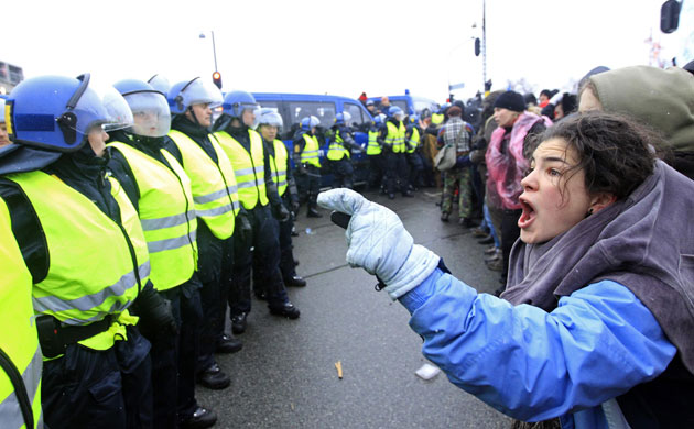 COP15 Reclaim Power: A protester shouts at police officers 