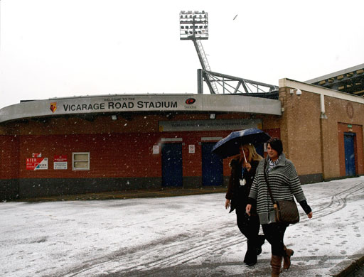 December weather: Two women walk in the snow past the Watford team home of Vicarage Road