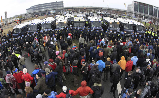 COP15 Reclaim power: COP15 Police officers stand in line in front of protesters 
