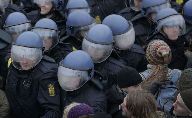 COP15 Reclaim power: The helmets of Danish riot police fog up as they push back demonstrators