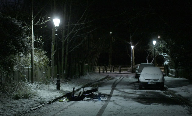 Snow in the UK: A paperboy falls from his bike after snowfall in London