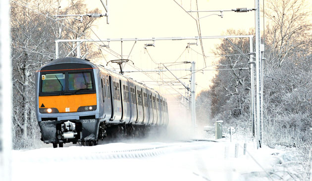 Snow in the UK: A train travels through the snow near Ingatestone, Essex