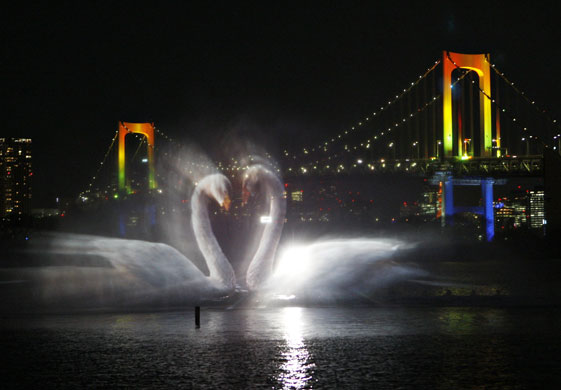 24 hours: A  swan is projected on a screen at Odaiba water illumination show in Tokyo