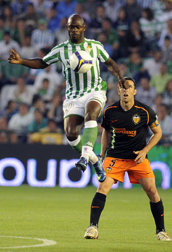 Transfer targets: Betis's Achille Emana (up) vies for the