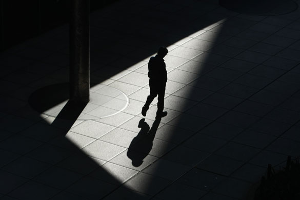 24 hours: A man walks on a footbridge in Shiodome business district in Tokyo