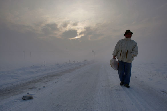 Snow around the world: Bosnian Mirko Savic walks on a snow covered road near Doboj