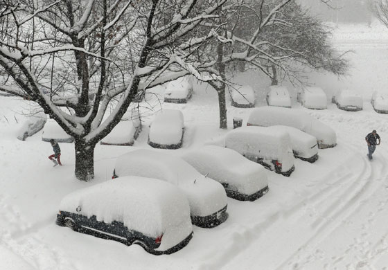 Snow around the world: Alexandria, Virginia, US: Vehicles are covered in snow during a blizzard