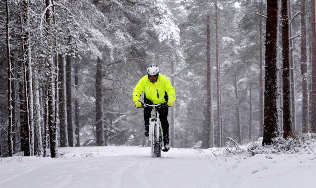Snow around the world: Scotland: A man cycles up a path in the Cairngorm mountain range