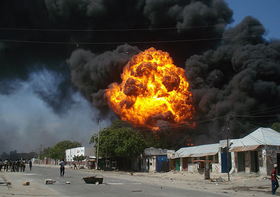 24 hours in pictures: Mogadishu, Somalia: A ball of fire erupts within a thick cloud of smoke