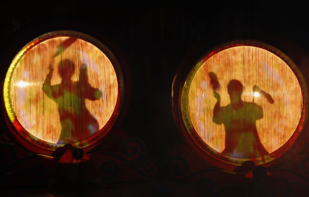 24 hours in pictures: Macau: Dancers perform inside drums during a cultural show