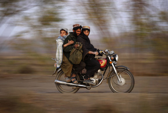 24 hours: Afghans ride a motorcycle