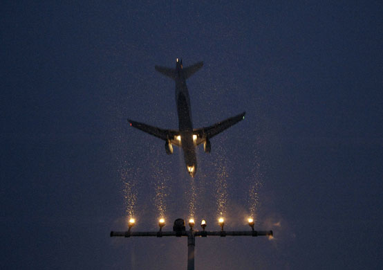 24 hours: Hanover,Germany: An airplane lands during heavy snowfall 