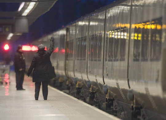 travel chaos: A guard waves off the first Eurostar train to Paris after cancellations