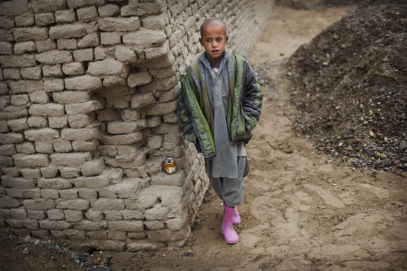 24 hours in pictures: Helmand province, Afghanistan: A youth during a shura, or meeting