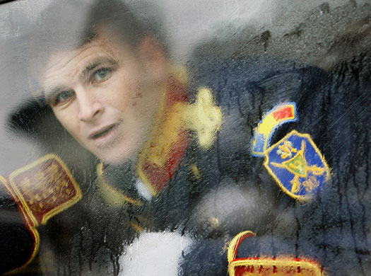 24 hours in pictures: Bucharest, Romania: A soldier looks out of the frozen window of a bus