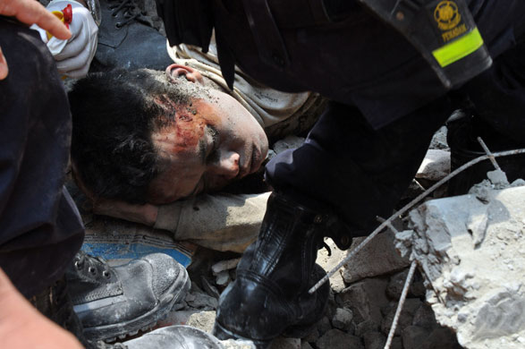24 hours:  Jakarta , Indonesia: A survivor is evacuated from a collapsed building