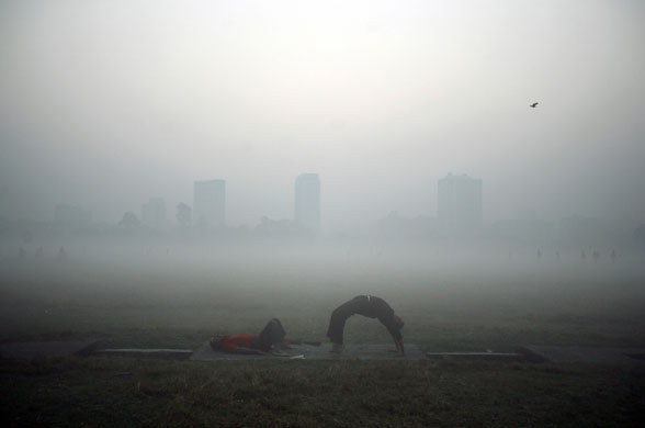 24 hours: Men exercise amid heavy fog at a park in Kolkata