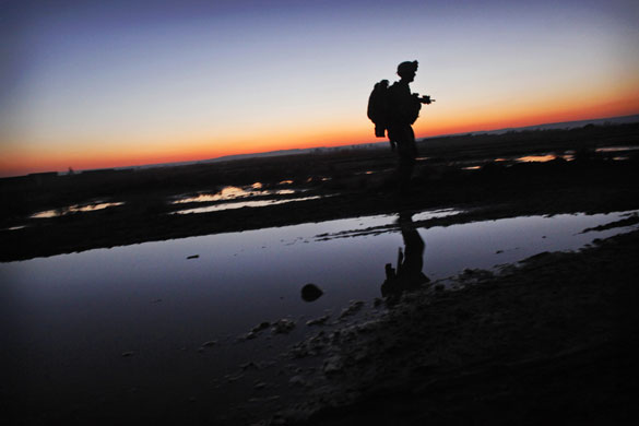 24 hours in pictures: Helmand province, Afghanistan: A US Marine patrols during an operation