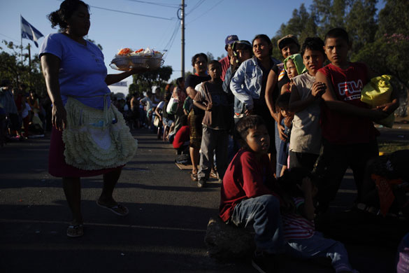 24 hours in pictures: Managua, Nicaragua: People wait for a delivery of toys