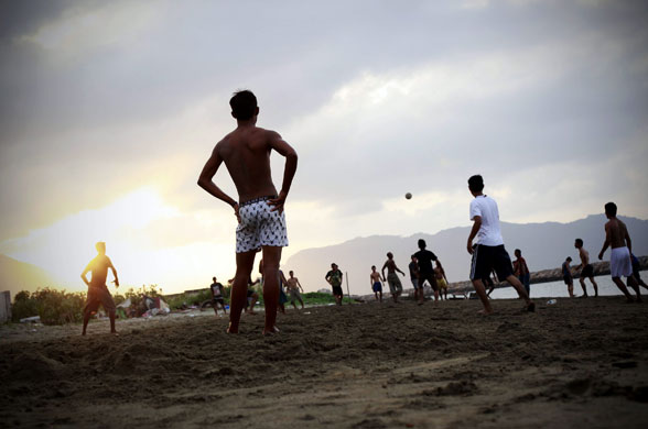 24 hours in pictures: Banda Aceh, Indonesia: Locals play football on the beach