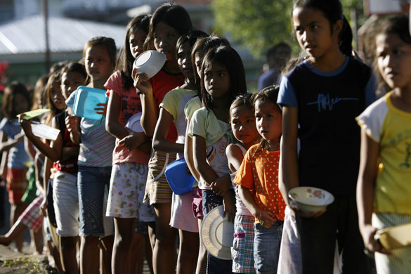 24 hours in pictures: Legazpi city, Philippines: Evacuees wait in line for free porridge