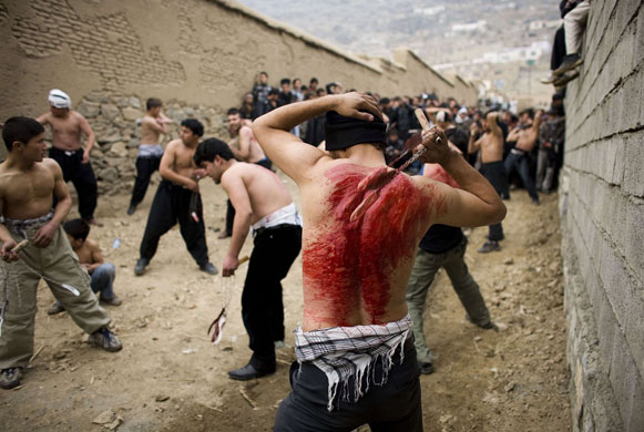 Ashura processions: Afghan Shi'ite Muslims flagellate themselves with chains during Ashura