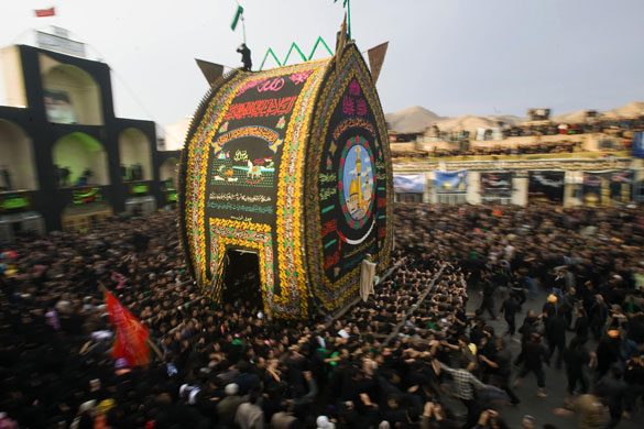 Ashura processions: ranian Shi'ite Muslims carry a religious symbol at Ashura festival