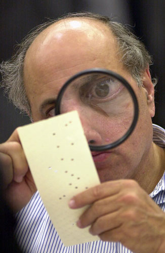 Pictures of the Decade: 24 November 2000: A judge examines a disputed US election ballot in Florida
