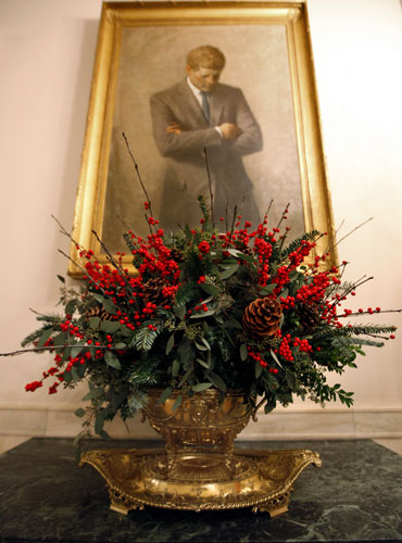White House christmas: Holiday greenery beneath the portrait of President John F Kennedy