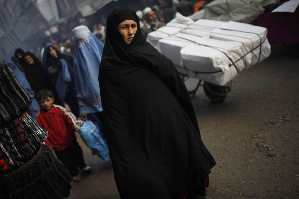 3 December 2009: Kabul, Afghanistan: A woman walks in a market