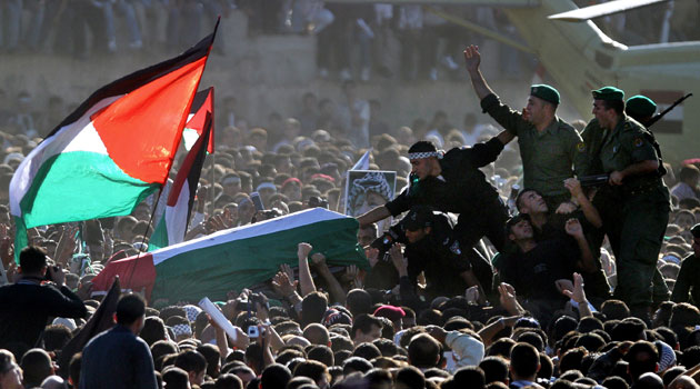 Pictures of the Decade: 12 November 2004:  Security men with Yasser Arafat's coffin